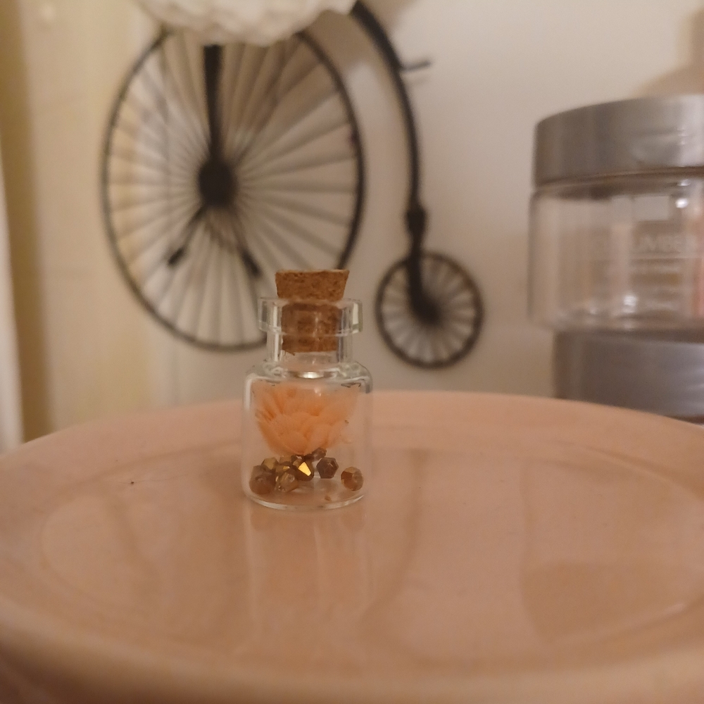 Tiny jar with gems and flower